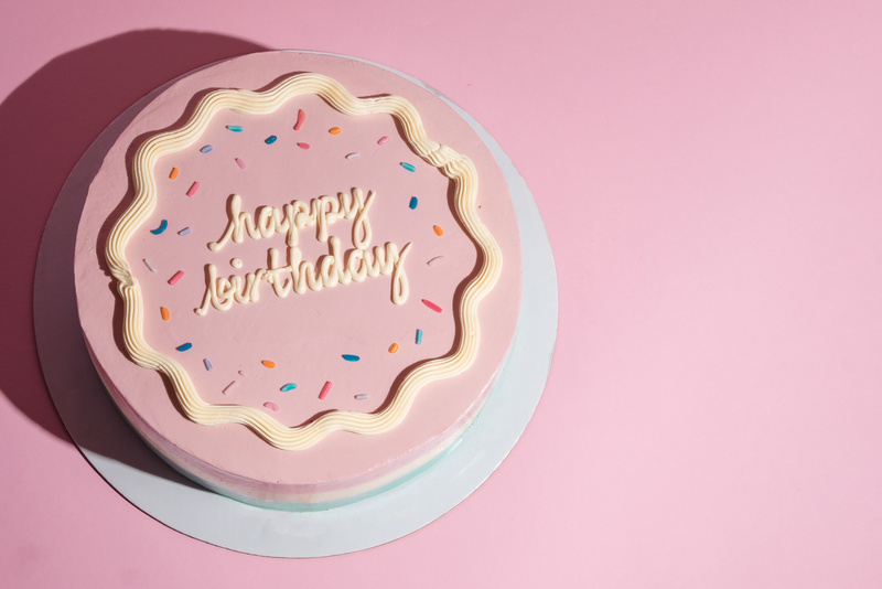 Pastel Pink Birthday Cake with Sprinkles and Frosting